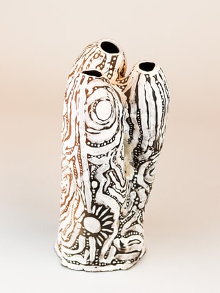 photograph of earthen ceramic sculpture, hand painted with patterns, front view, thumbnail