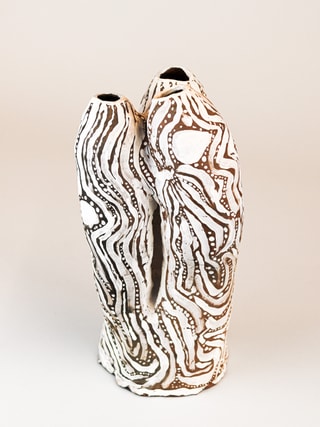 photograph of earthen ceramic sculpture, hand painted with patterns, back view, thumbnail